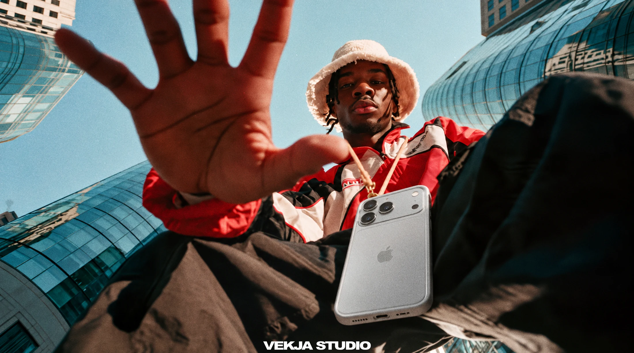 Streetwear portrait with a phone and an outstretched hand