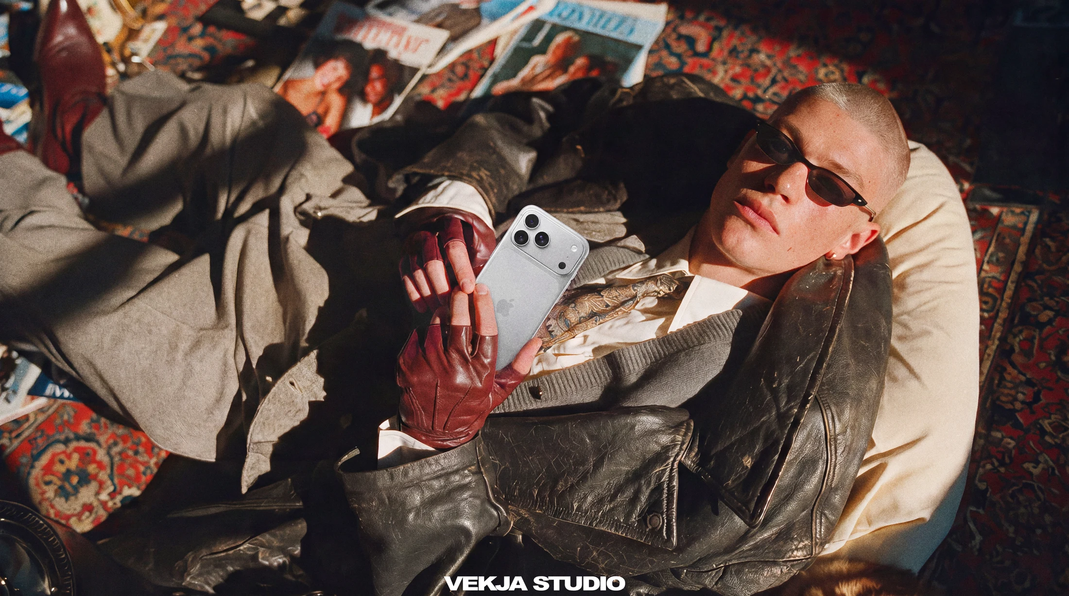Reclining portrait with a silver phone