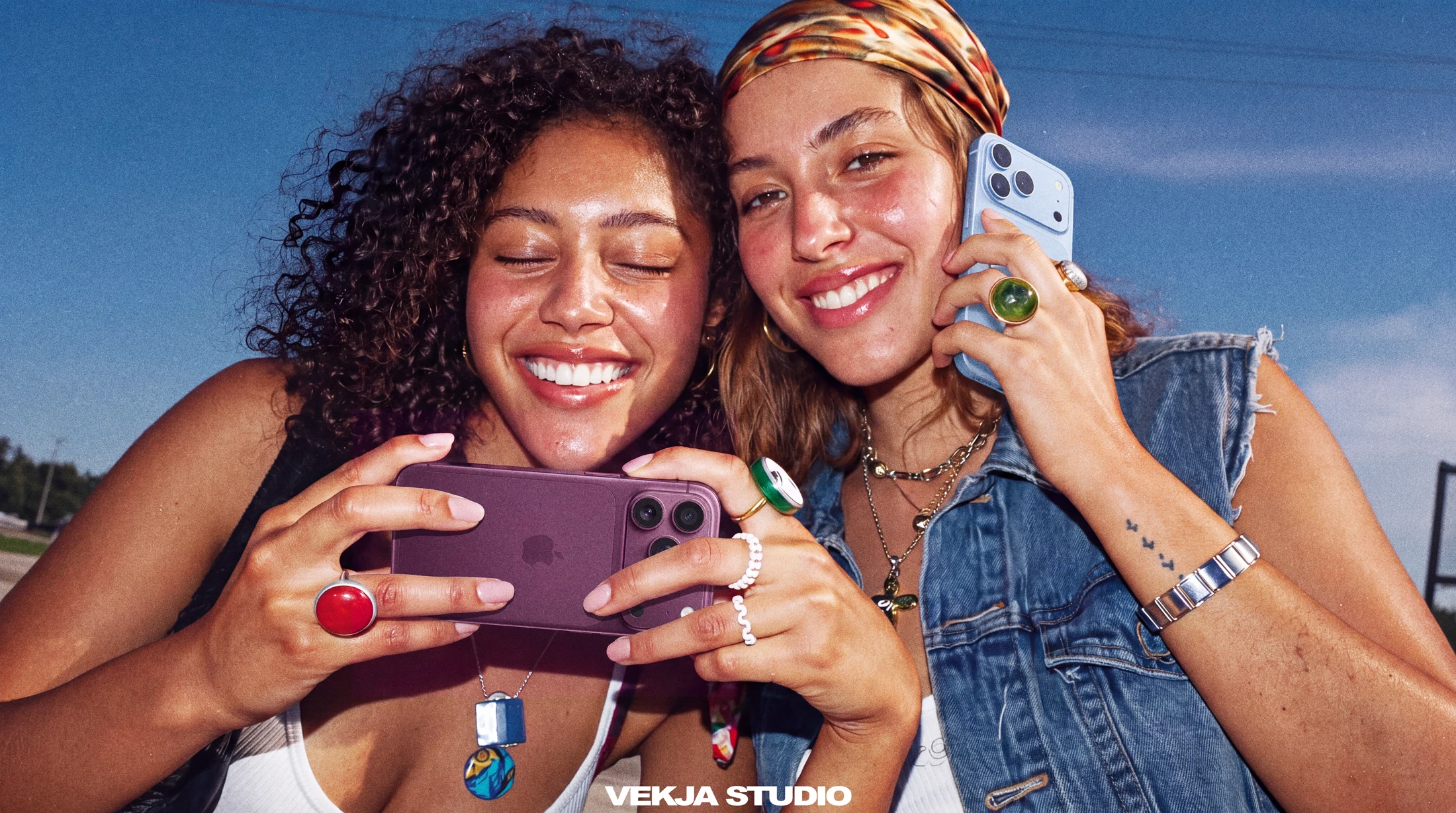 Two friends laughing with their phones