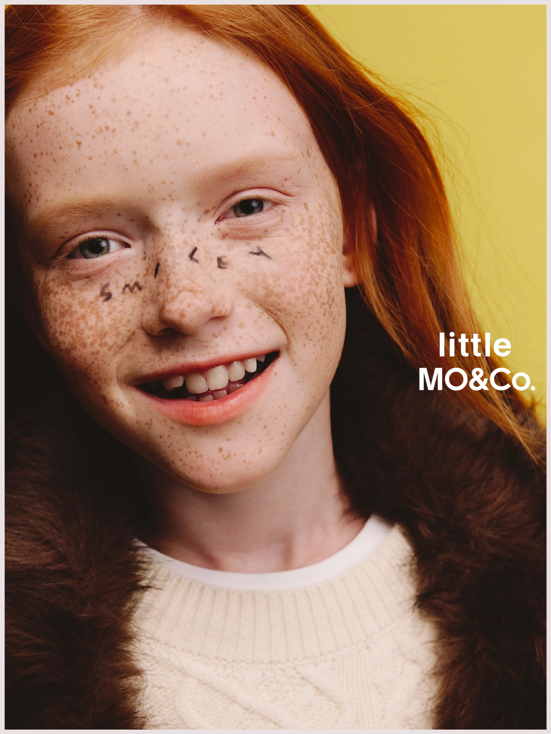 Close-up portrait of a red-haired child for little MO&Co.