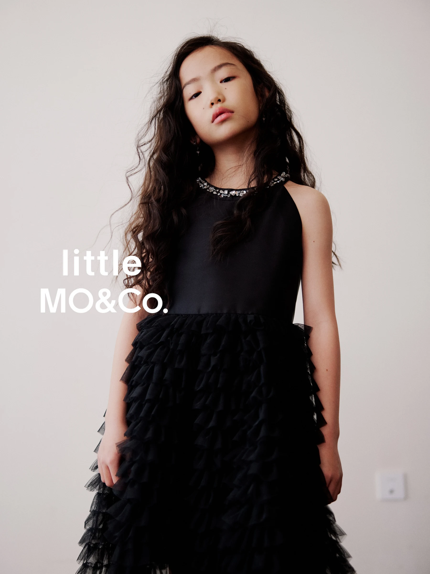 Portrait of a girl wearing a black ruffled dress