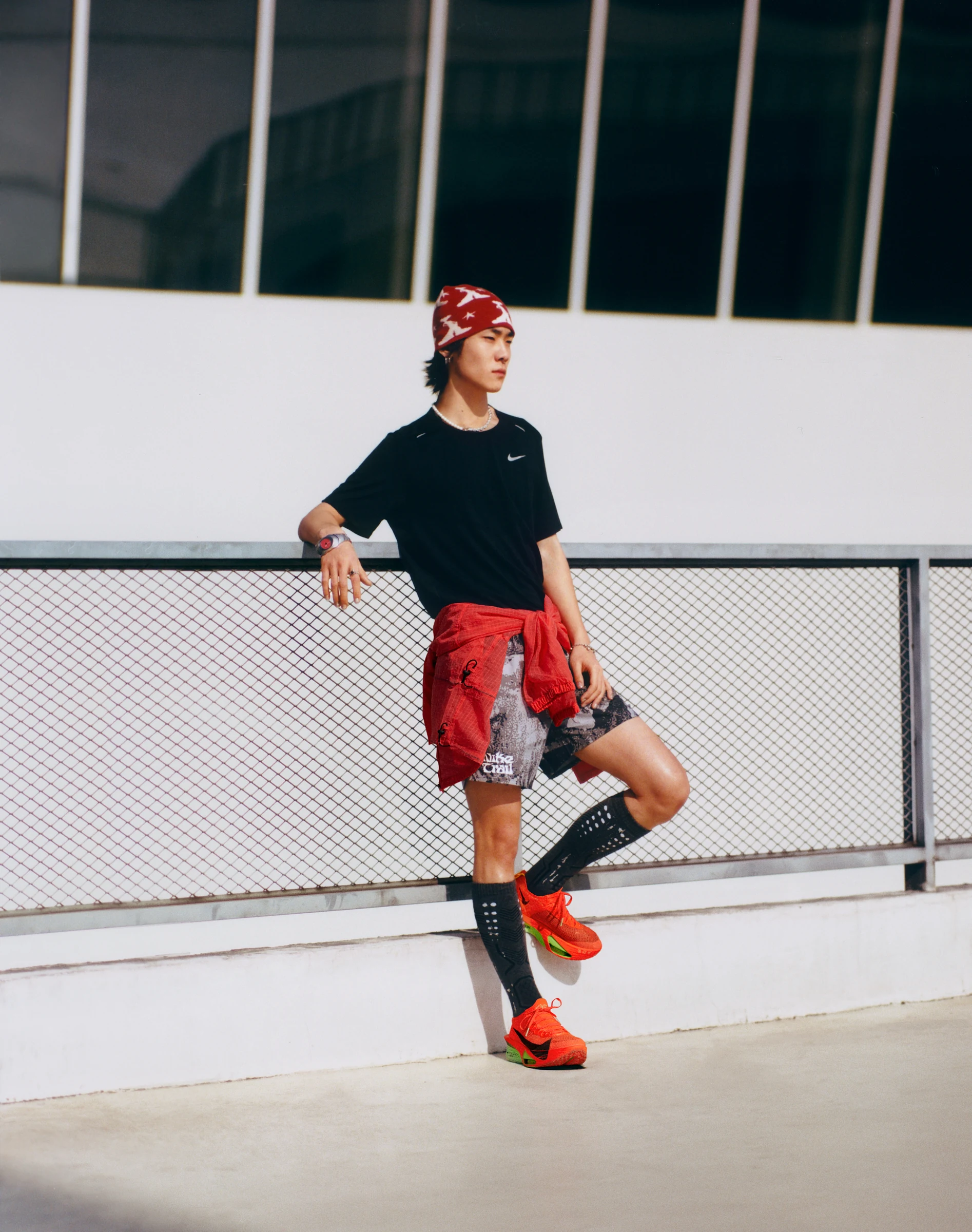 NIKE court portrait in a black shirt and red jacket
