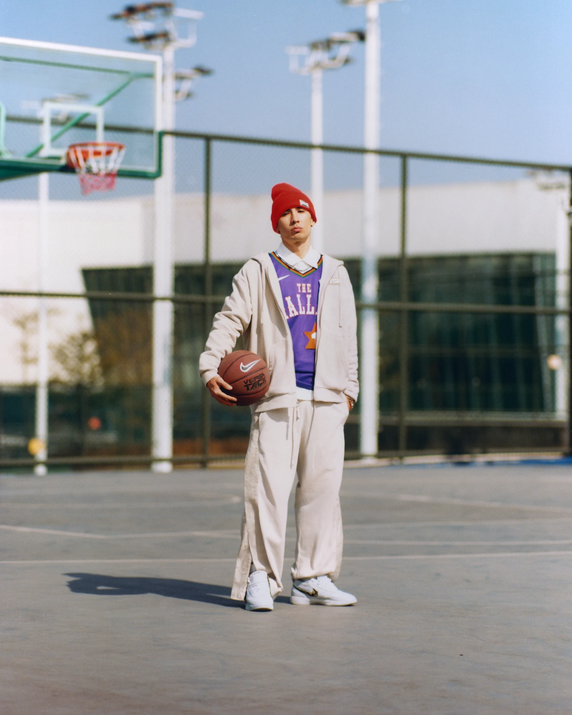 NIKE basketball portrait in a red hat and purple jersey