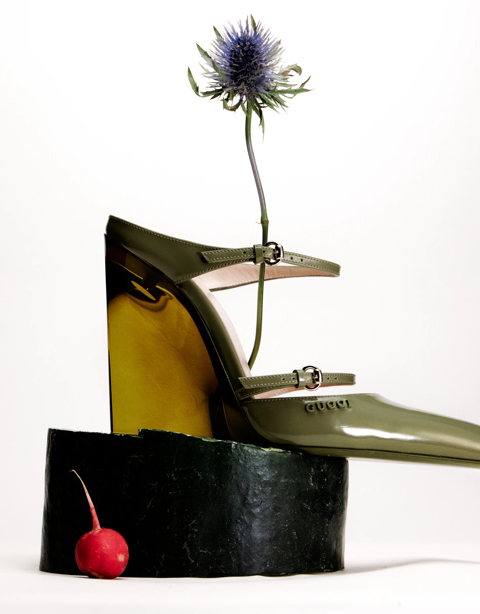 GUCCI heeled shoe with a flower and radish in a sculptural still life