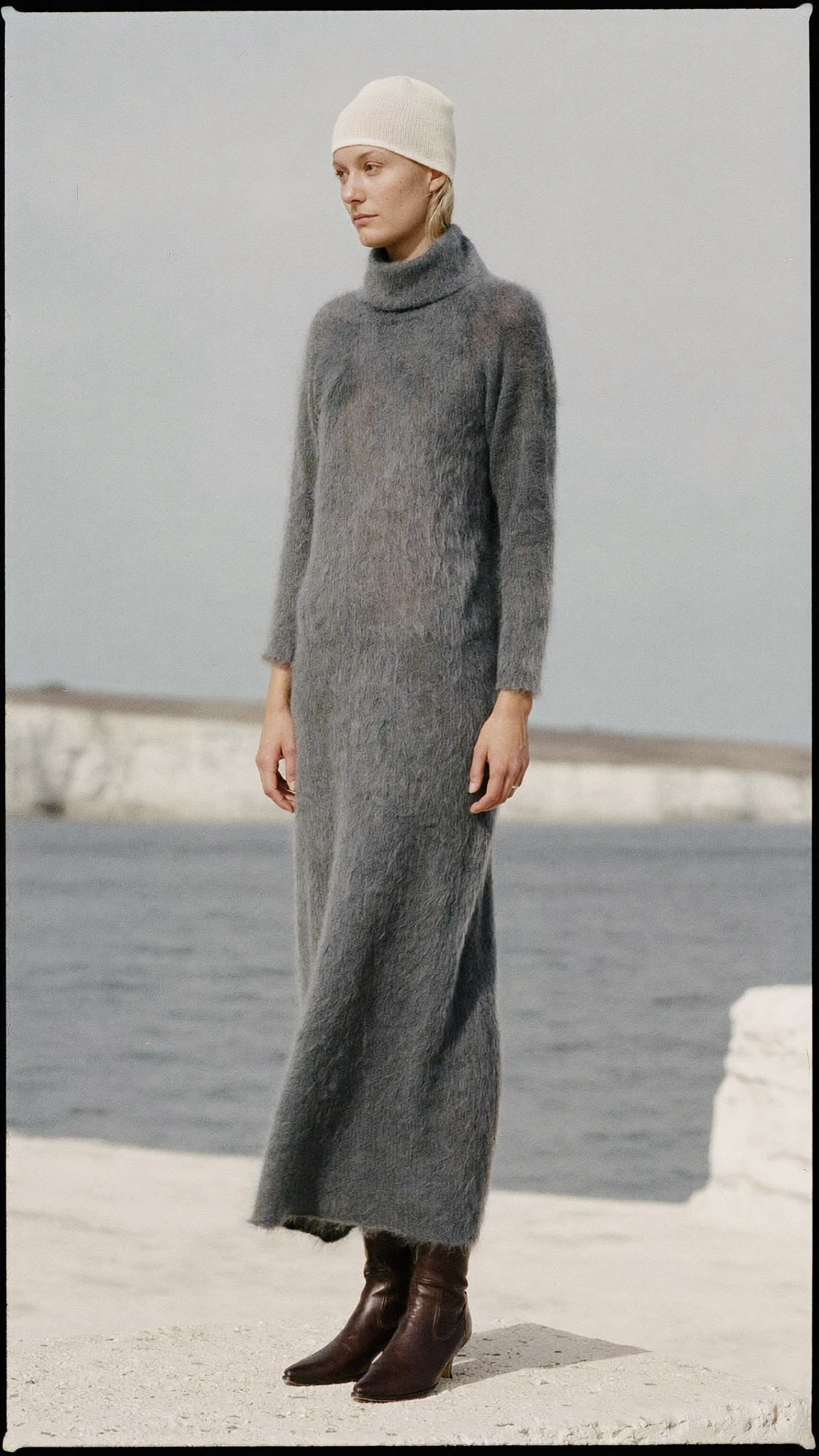 Grey knitted dress beside the sea
