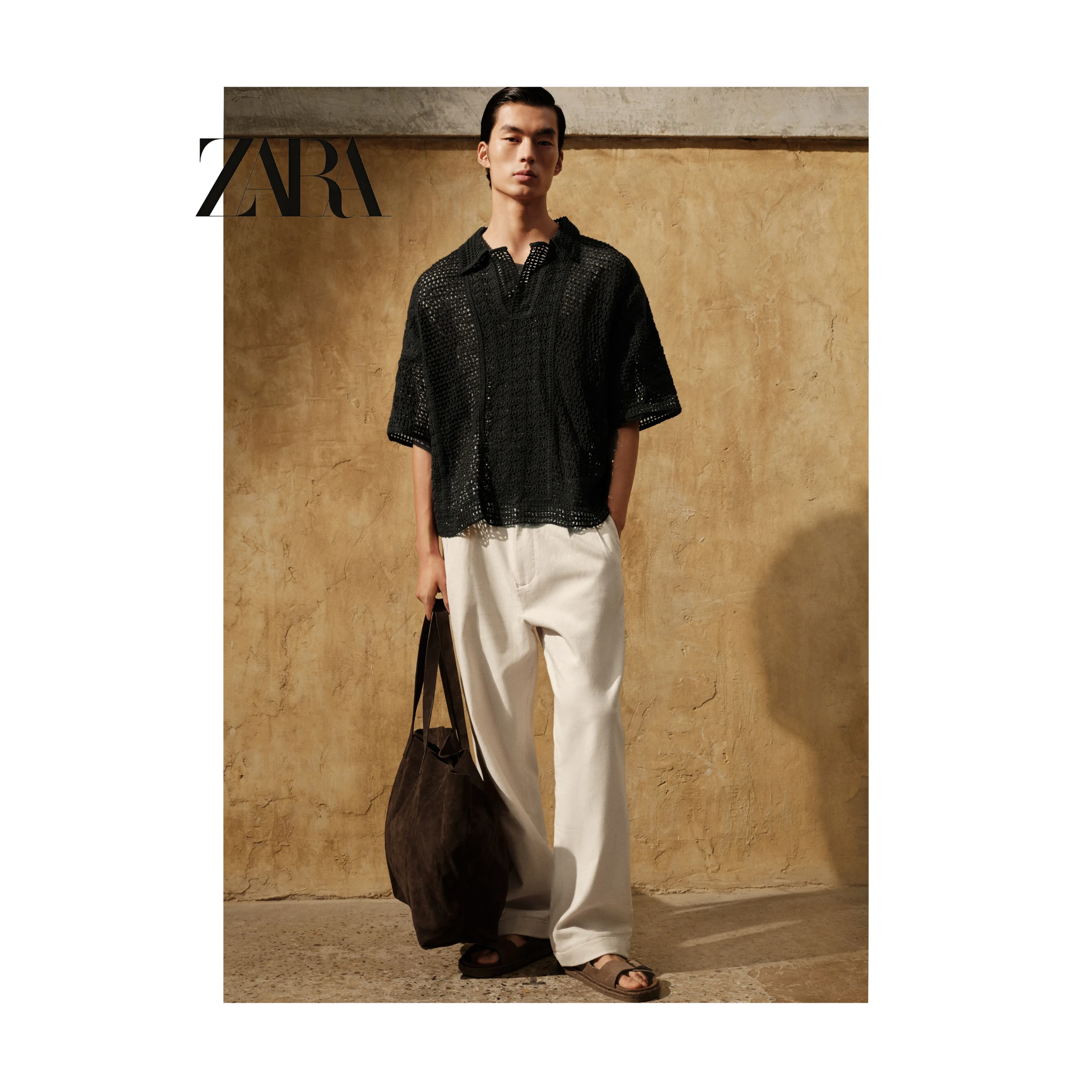 ZARA menswear portrait in a black shirt and white trousers
